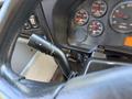 Close-up of the steering column in a 2013 International CE300 showing the dashboard gauges and a control stalk for lights or wipers