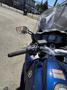 A 2016 Yamaha FJR1300AE motorcycle featuring a blue body with a clear windscreen handlebars and a digital display on the dashboard