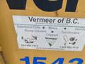 A sticker featuring the Vermeer Corporation logo and a list of machinery including directional drills stump grinders and trenchers displayed on a yellow surface
