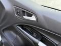 Close-up of the interior door panel of a 2017 Ford Transit Connect featuring window controls and a door handle