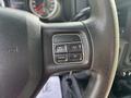 Close-up of the steering wheel controls in a 2013 RAM 5500 featuring buttons for on/off, cancel, and resume/set functions