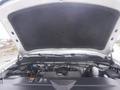 A 2015 Chevrolet Silverado 1500 with its hood open revealing the engine compartment and various engine components