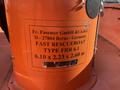 A label on an orange boat indicating it is a 2007 Fassmer 20 Foot Fast Rescue Boat with specifications for type and dimensions