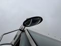 Side mirror of a 2012 Ford E-450 Super Duty with a curved reflective surface and a mounting arm attached to the vehicle's body
