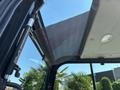 Close-up view of the interior roof and mesh sunshade of a 2010 Bobcat E80 excavator cabin