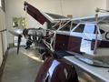A 1986 Sorrell Hiperbipe SNS-7 amateur-built aircraft with a red and white color scheme featuring an exposed engine and a propeller in the foreground