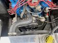 Close-up view of the engine compartment of a 1968 Ford Mustang Two Door Convertible featuring red wiring and a large black hose leading to the engine block