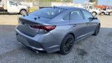 A 2018 Hyundai Sonata in silver with a sleek design featuring a sporty rear profile and dark alloy wheels