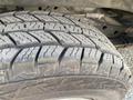 Close-up of a tire from a 2023 GMC Savana showing detailed tread patterns and wear indicators