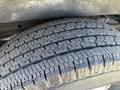 Close-up of a treaded tire from a 2017 Chevrolet Express showcasing deep grooves and an even wear pattern