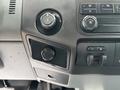 Dashboard controls of a 2013 Ford F-250 SD featuring knobs for climate control and power options