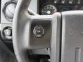 Close-up of a 2015 Ford F-350 steering wheel showing controls for setup and information