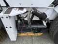 A 2012 Global M4 model featuring a mechanical broom attachment with a hydraulic system and various control components visible on the chassis