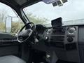 Interior view of a 2011 Ford F-650 featuring a steering wheel dashboard and control panel with entertainment system and various knobs