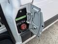 A fuel door of a 2022 Mercedes-Benz Sprinter with a red diesel cap and labels indicating diesel fuel type and specifications