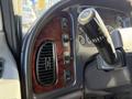 Interior dashboard of a 2012 Freightliner M2 106 with control buttons and a gear shift lever in focus