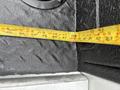 A measuring tape extended along the interior of a 2013 Ford F-250 SD showing measurements in inches and feet