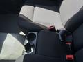 Interior view of a 2011 Chevrolet Colorado showing the front seats and center console with cup holders