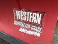 A red plow attachment with a torn label reading WESTERN CONTRACTOR GRADE