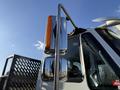 A 2017 International 4300 truck with chrome mirrors and an orange-refractor light on the side