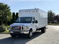 A white 2021 Ford Econoline truck with a large box cargo area and a front grille featuring the Ford logo