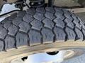 Close-up of a 2013 Ford F-550 tire showing the tread pattern and wheel rim with visible details of the rubber texture