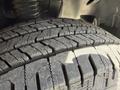 Close-up of a textured tire tread of a 2022 Mercedes-Benz Sprinter showcasing deep grooves and patterns designed for traction