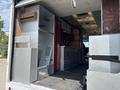 A 2011 Workhorse W62 with a partially open interior showing metal cabinetry and workspaces designed for food service or vending