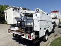 A 2008 Ford F-550 utility truck with a raised bucket lift and various tool compartments on the side