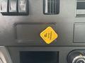 A yellow parking brake release knob labeled "PARKING BRAKE" mounted on the dashboard of a 2025 Peterbilt 536