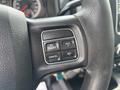 Close-up of a steering wheel with control buttons for cruise control on a 2016 RAM 5500