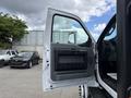 A 2017 Ford F-750 truck with an open driver's side door showcasing the interior handle and control panel