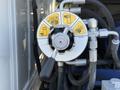 A mechanical control valve with directional indicators and a lever on a vehicle's hydraulic system