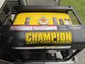 A Champion generator with a yellow top and black casing featuring warning labels and controls for power equipment