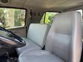Two gray leather seats inside a 2006 Sterling Acterra truck with a steering wheel visible in the foreground