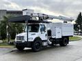 A white 2015 Freightliner M2 bucket truck with a mounted lift and utility body parked on a roadway