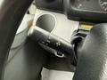A close-up view of the steering column controls of a 2015 Hino 195 including the turn signal lever headlight switch and dashboard indicator lights