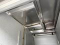 A 2007 Ford F-550 with a metallic interior featuring exposed pipes and a textured ceiling structure
