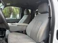 Interior view of a 2015 Ford F-450 featuring gray cloth seats with a center console between the front seats