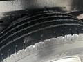 Close-up of a tire on a 2013 Ford E-350 showing deep tread patterns and a well-maintained surface