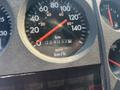 Close-up of the speedometer and odometer in a 1999 Freightliner FL80 showing 240312 kilometers and speed measurements in kilometers per hour and miles per hour