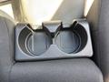 A black plastic cup holder with two round spaces for cups located in the center console of a 2011 Chevrolet Colorado