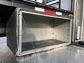 An empty storage compartment of a 2010 International 4300 truck without any items inside