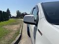 A white 2017 Chevrolet Colorado with a side mirror in focus showcasing its design and features
