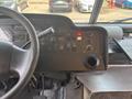 The dashboard of a 2018 Ford Econoline featuring a steering wheel control panel with various switches gauges and a cup holder