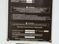 A warning label affixed to a vehicle detailing safety instructions and notes about electrical insulation and equipment features