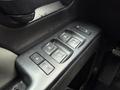 A close-up of the door control panel in a 2015 GMC Sierra 1500 featuring window and door lock buttons