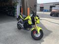 A bright yellow 2018 Honda Grom motorcycle with a compact design featuring a small frame and prominent front headlight