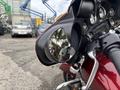 A 2009 Harley-Davidson Road King showcasing its handlebars and side mirror reflecting the surroundings