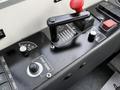 A control panel featuring levers and buttons labeled for various functions including start engine and a speedometer gauge
